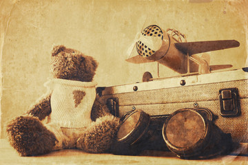 Photo of vintage toy plane and cute teddy bear
