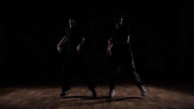 Two Boys dancing in the dark.