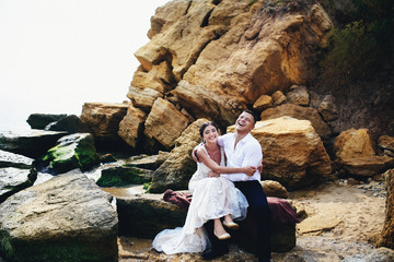 Bride and groom on the rocks