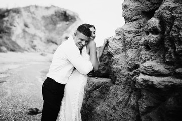 Fototapeta premium Bride and groom near the rock