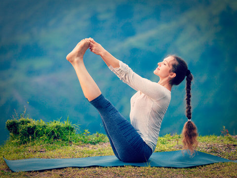 Woman doing Ashtanga Vinyasa Yoga asana outdoors
