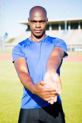 Naklejka premium Athlete warming up in a stadium