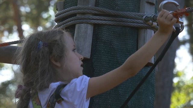 Little Girl Trains at Extreme Park. Climbing