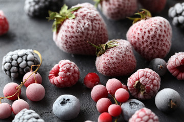 Frozen berries on a black wooden table