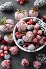 Frozen berries on a black wooden table