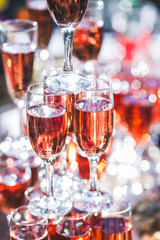 Stack of glasses of champagne at the reception in the open air