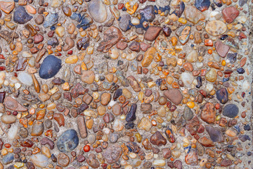 Texture of cement floor aged with small colored stones