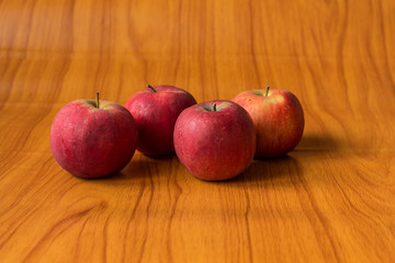 Ripe red apples on wooden background