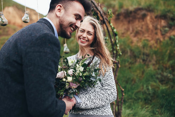 Bride and groom with bouquet of flowers