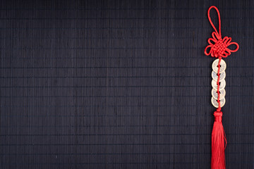 Obraz premium chinese lucky coins on black bamboo mat