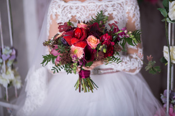 Beautiful Weding bouquet of different flowers in bride hands