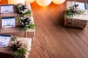 Decorated gift boxes and garland on the wooden background