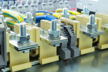 beige bolt bushing terminals on the DIN rail located on the mounting panel is connected to them wires, fixed retainers