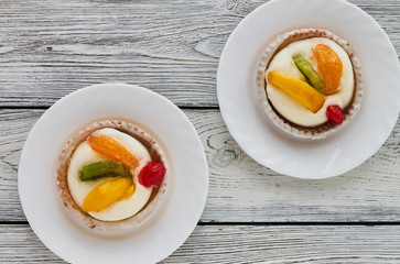 Tartlets with cream and fruits, orange, kiwi, cherry