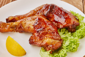 Grilled chicken legs with vegetables and lemon