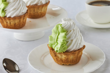Air cake in a basket and coffee on a wooden background