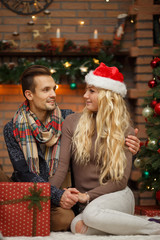 Obraz na płótnie Canvas Happy couple near Christmas lights