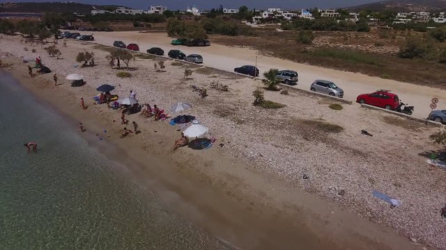 Aerial of beach with people recreating on Greek island of Paros.