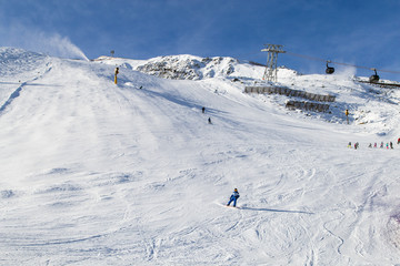 Fototapeta na wymiar Skiers descend from the mountains. ski resort. ski-lift. Solden, Austria