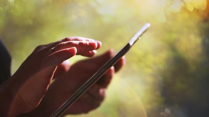 Man running in a tablet computer outdoors