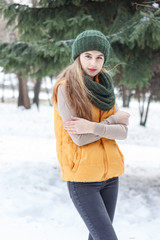 Beautiful girl on the nature in the winter outside in winter hat