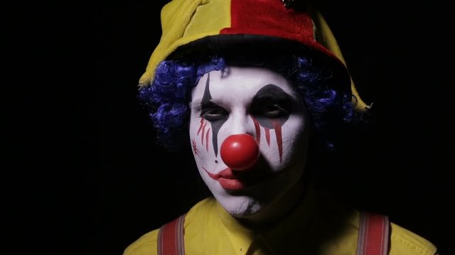 Evil, horror clown man looking into camera. HD