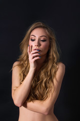      Sensual topless beautiful blond haired girl isolated on black background, fashion pose, arms crossed, shy 