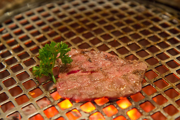 medium rare beef grill on metal mesh in japan restaurant, Yakini