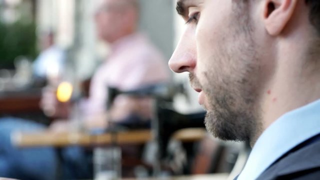 Businessman looking on creased paper with outcomes, steadycam shot
