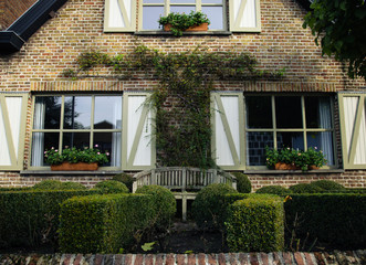 Fototapeta na wymiar House facade and garden, Bruges, Belgium
