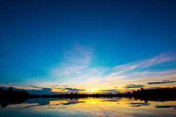 Beautiful sunset over lakt with blue sky