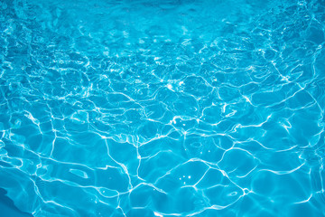 Beautiful ripple water surface with sun reflection in swimming pool