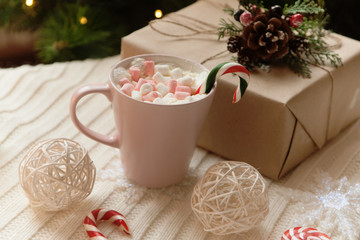 big mug of hot cocoa and sweet christmas candy