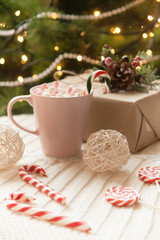 big mug of hot cocoa and sweet christmas candy