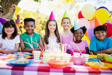 Group of children smiling and posing during a birthday party