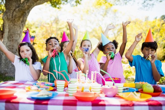 Cute mixed race children having fun during a birthday party
