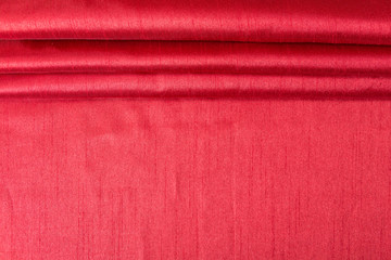 Fototapeta premium Rich red wavy fabric texture / background.