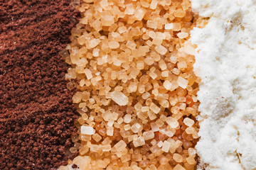Fototapeta na wymiar cane sugar, powdered sugar, cocoa powder closeup