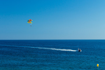 Tourists parasailing on Costa Dourada Beach in Salou, Spain