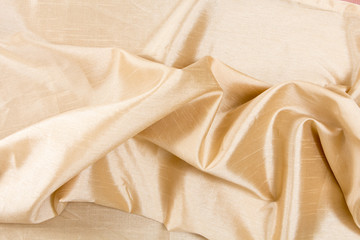 Golden wavy fabric texture / background.