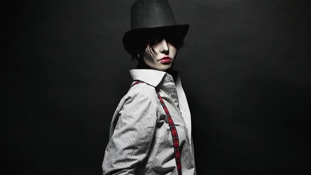 Frightened girl with Halloween makeup posing with her arms crossed or folded isolated on black background in studio. Halloween concept.