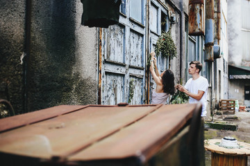 beautiful and happy boy and girl standing at the shabby door