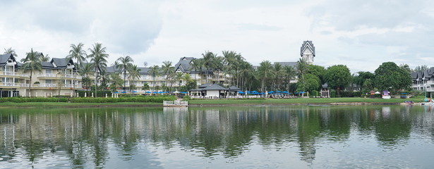 Lovely view of the lake near luxurious tropical resort over cloudy sky during day