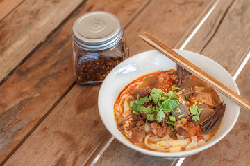 Rice noodles with spicy pork sauce (Nam ngiao) is a noodle soup or curry of the cuisine of the Tai Yai people. Nam ngiao has a characteristic spicy and tangy flavor. Thai food.