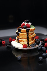 Pancakes with berries and maple syrup