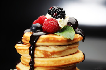 Pancakes with berries and maple syrup