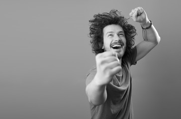 portrait of urban bearded man with funny hair against color back