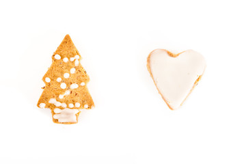 Gingerbread tree and heart cookies with icing, on white background