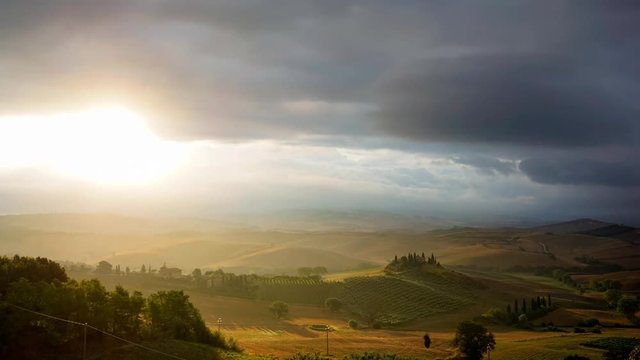 Rain clouds and sun rays over the hills of Toscana, Italy