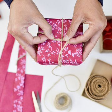 young man wrapping a gift